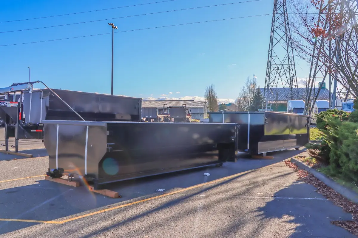 Roll-off dumpster ready for waste disposal at job site for Concrete Dumpster Rental in Norwood